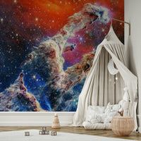 The pillars are composed of glowing gas and dust in shades of blue, purple, and pink.
