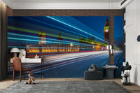 A wall mural featuring a vibrant city scene at night.

