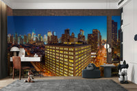 A wall mural featuring a vibrant city skyline at night.

