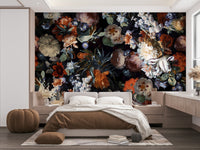 The image shows a full wall with several large flowers on a dark, moody background.

