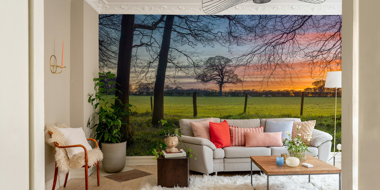 A wall mural featuring a peaceful, natural meadow scene.

