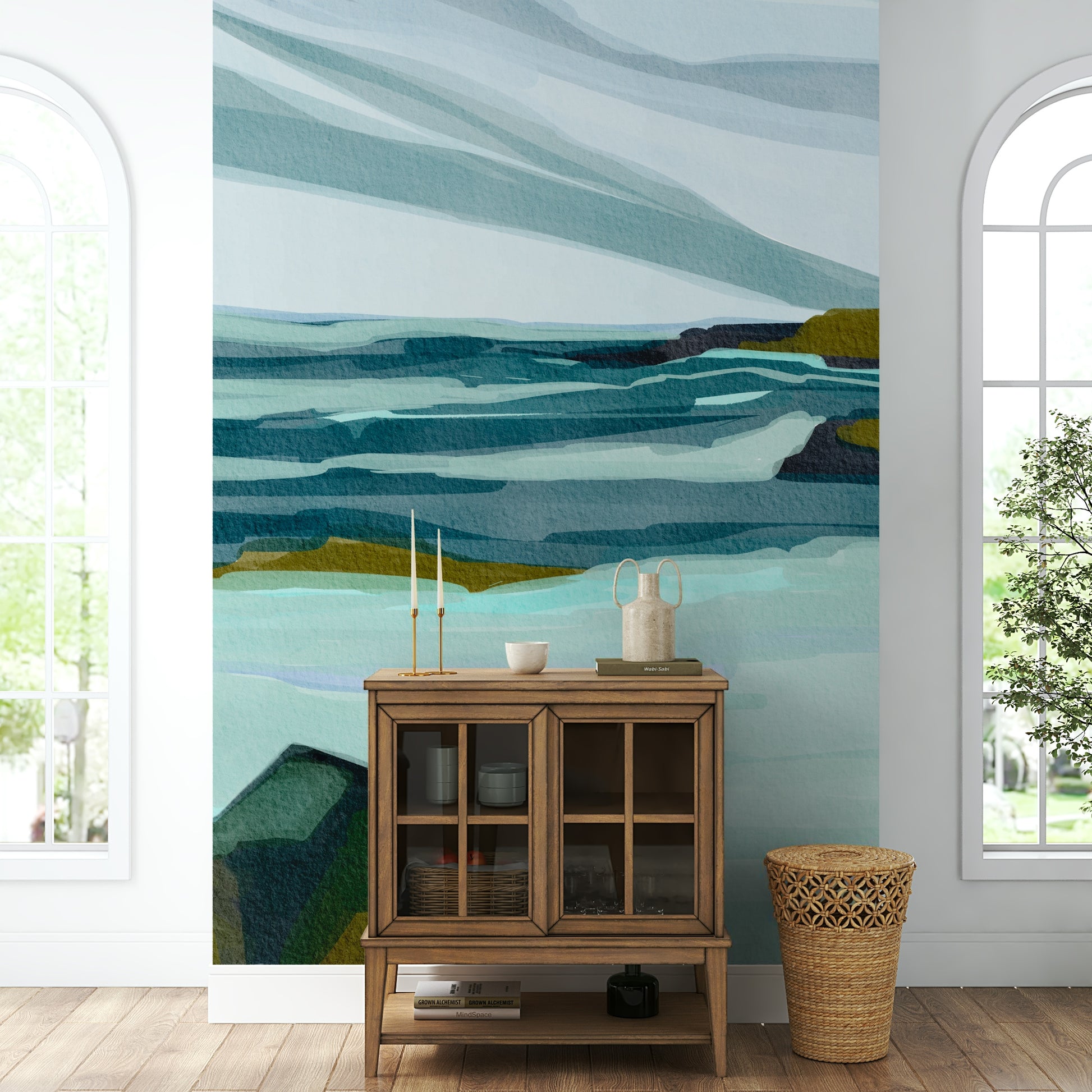 The mural is installed in a calm living room behind a simple, light-colored sofa.


