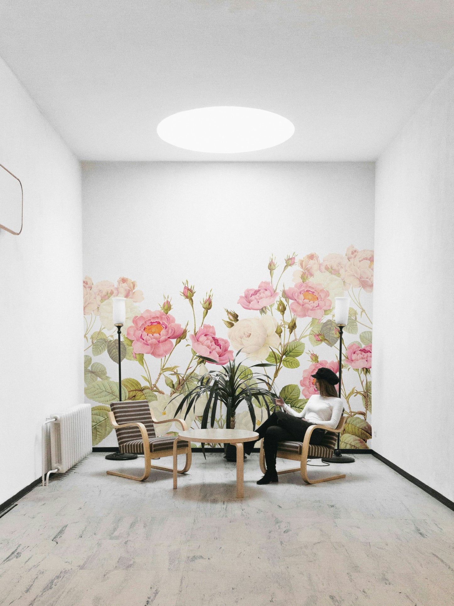 Soft green and gray leaves surround the rose blossoms.
