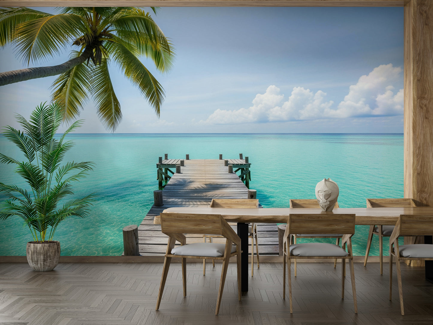 A wooden pier extends out into calm, clear turquoise water.
