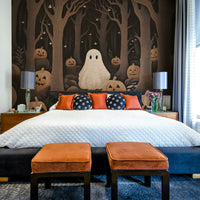 A peaceful wall mural with a whimsical ghost and pumpkins.

