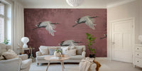 A peaceful wall mural with a design of cranes.

