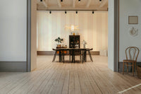 The design features a repeating pattern of classic stripes and delicate flourish shapes.

