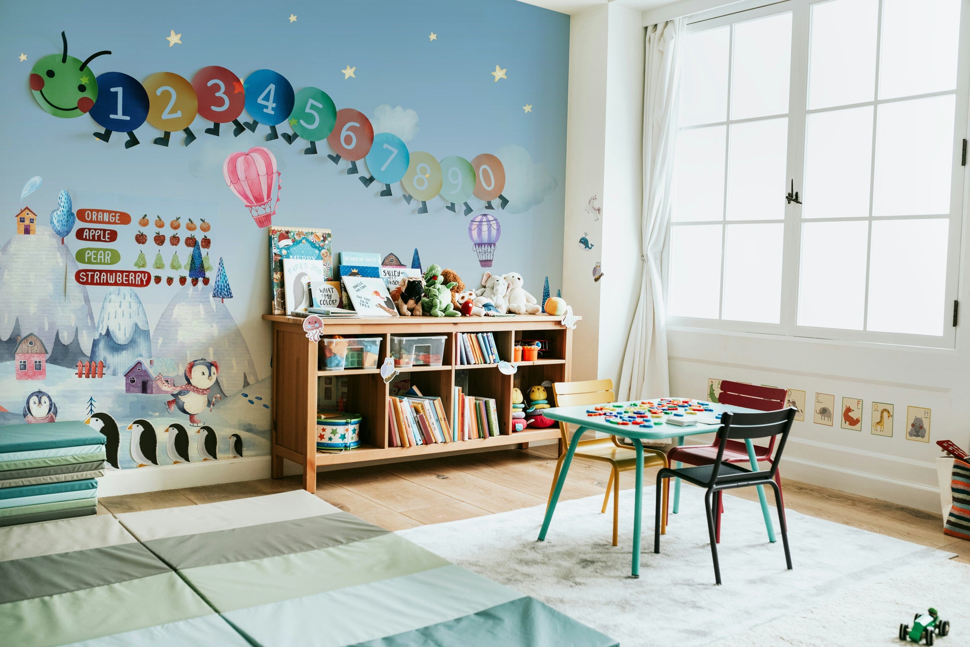 The design features a repeating pattern of soft, delicate penguins in a snowy village.

