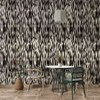 A bedroom decorated with a black wallpaper

