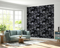 A dining room decorated with a dark floral mural

