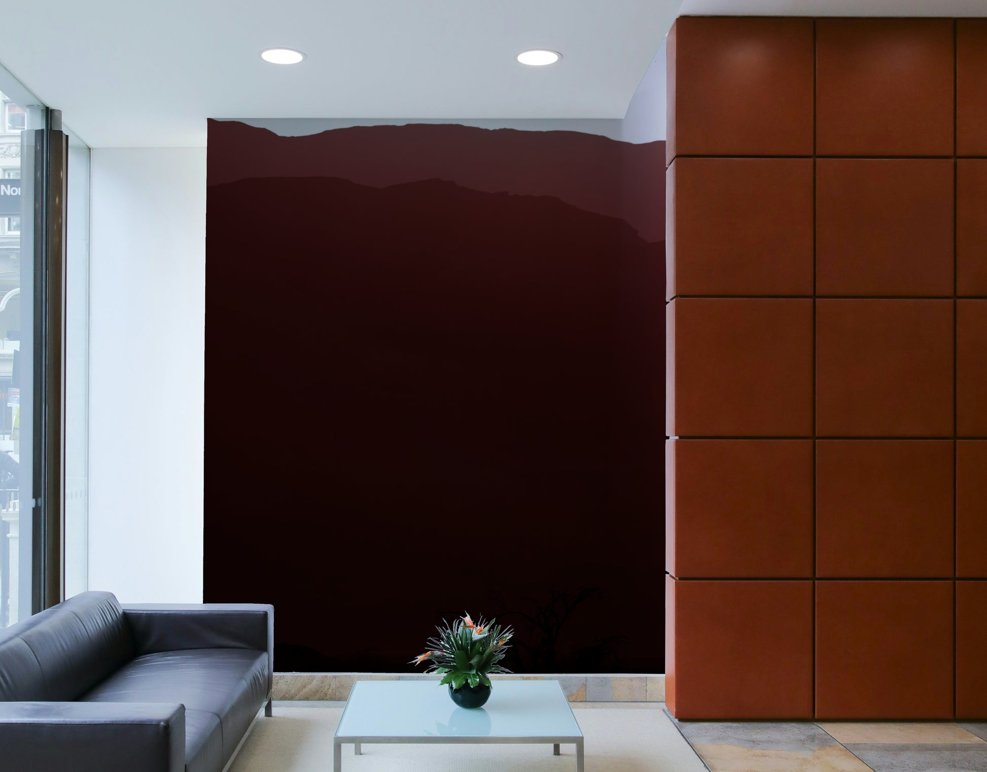 A living room with the mountain landscape wall mural.

