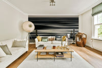 A contemporary living room with a large ocean wave wall mural.

