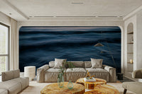 A contemporary living room with a large ocean wave wall mural.

