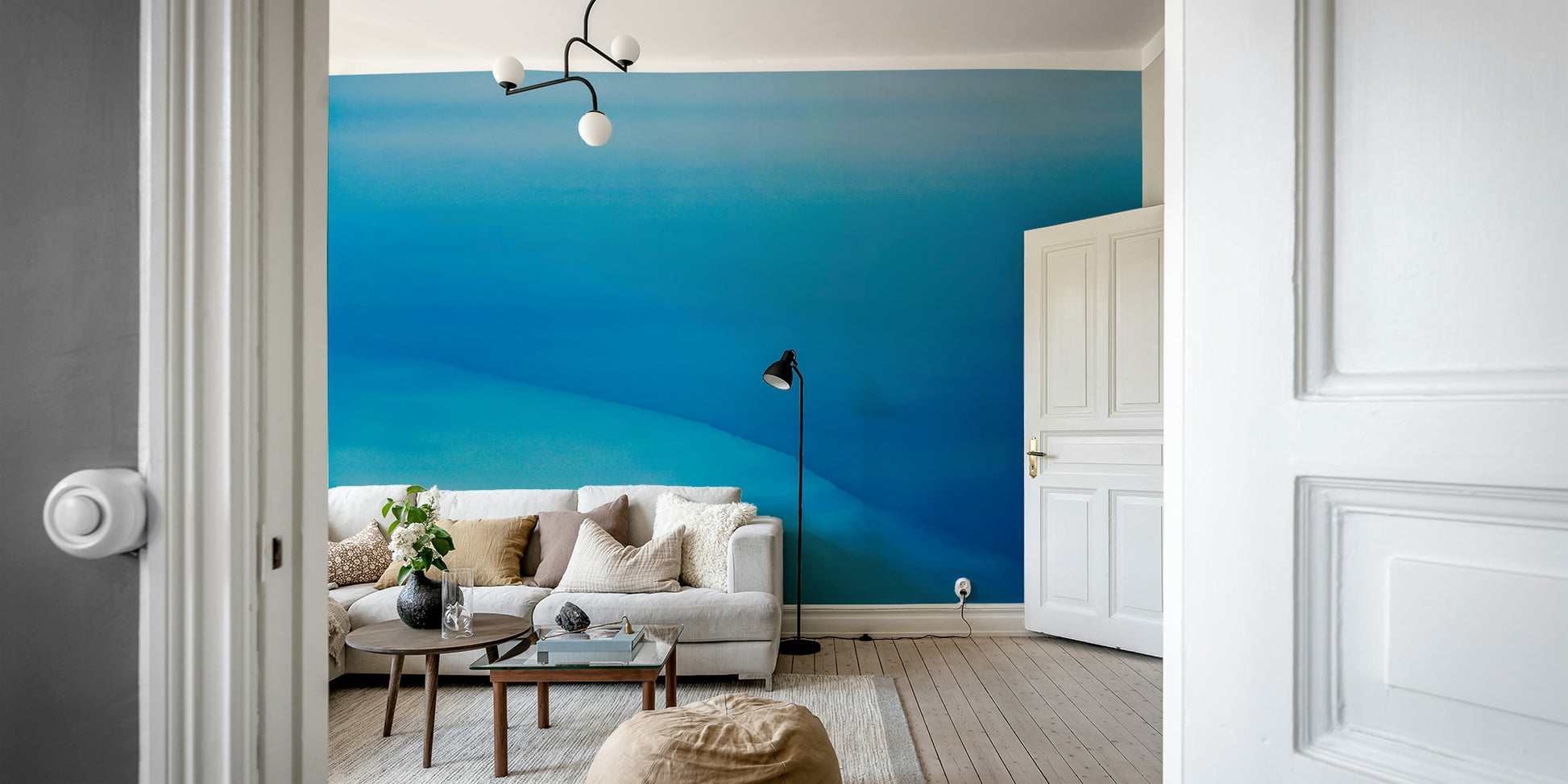 An artistic desert landscape mural on minimalist wallpaper.

