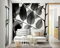An artistic leaf pattern mural on minimalist wallpaper.

