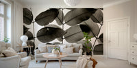 An artistic leaf pattern mural on minimalist wallpaper.


