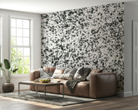 An artistic expressive ink mural on minimalist wallpaper.