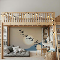 Wall mural with flamingos flying gracefully under a glowing evening sky.