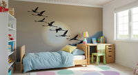 Decorative mural featuring a flock of flamingos silhouetted against a dusky, warm-toned sky.