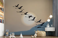 Wall mural depicting flamingos flying over calm waters at dusk with pastel skies.