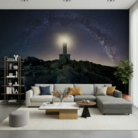Wall mural depicting a lighthouse beacon shining through a starry, celestial backdrop.