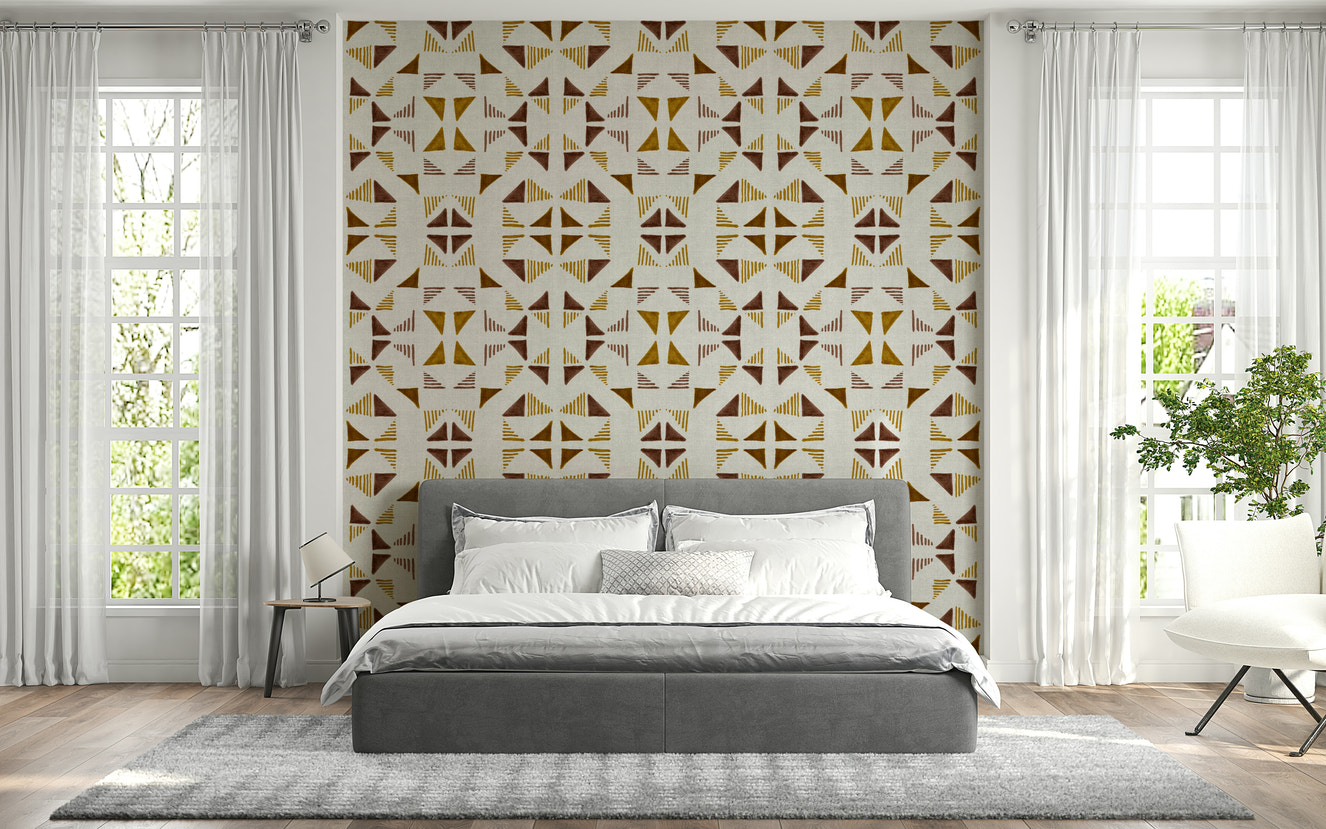 Geometric wall mural with warm-toned triangle patterns in shades of beige, terracotta, and gold.