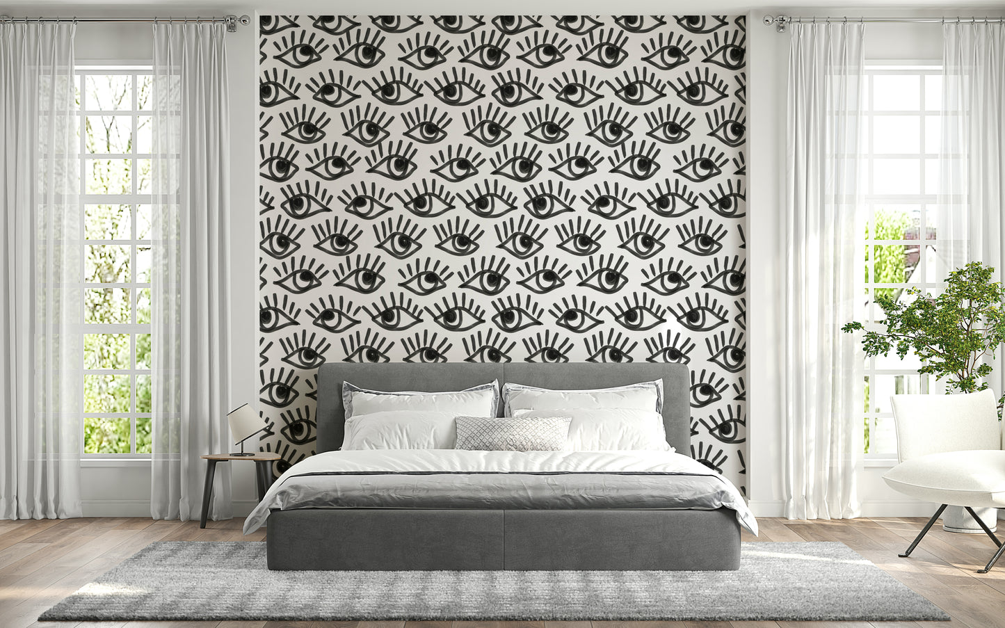 Decorative wall mural with intense staring eyes in grayscale for a dramatic effect.
