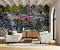 Canal bridge wallpaper wrought iron railing bicycles blossoms urbanity.