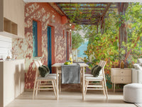 Greek stone path wall mural beside house with wooden arbor structure.