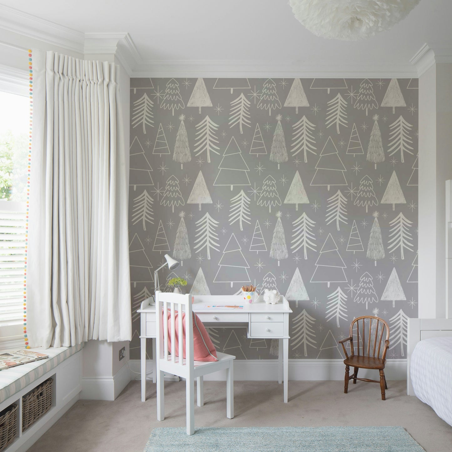 A gentle gray wallpaper featuring playful sketched evergreens and star shapes.
