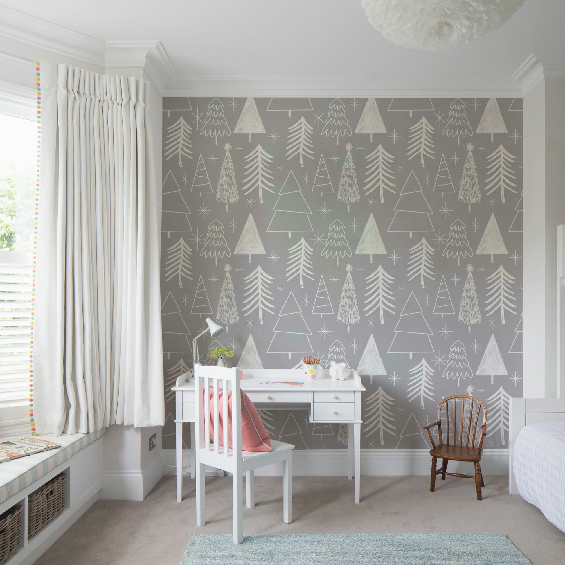 A gentle gray wallpaper featuring playful sketched evergreens and star shapes.