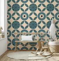 Teal-toned geometric wallpaper with alternating circles and leaf clusters in a mid-century style.