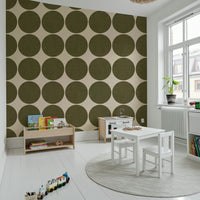 Repeating pattern of earthy olive round shapes with a subtle woven texture on a neutral backdrop