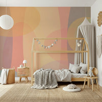 Blended ovals in beige, coral, and muted greens creating a peaceful abstract wallpaper pattern.