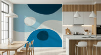 Soft overlapping shapes in cool blue shades forming a serene abstract wallpaper pattern.