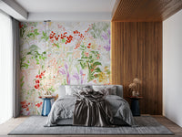 Hand-painted meadow wallpaper featuring flowing greenery and vibrant blossoms on a light background.