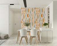 A warm-toned atomic wallpaper with orange, teal, and beige oval shapes in a rhythmic pattern.