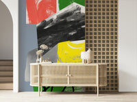 A vibrant abstract wallpaper blending sweeping black paint with bright red, blue, green, and yellow accents.