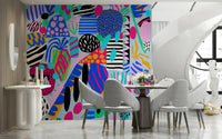 A bold party-inspired wallpaper with overlapping colorful elements and quirky graphic textures.