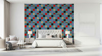 Red, cream, purple, black, and baby blue checkerboard wallpaper accented with quirky illustrated eyes.