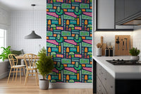 An eclectic boho wallpaper featuring playful floral patterns in vivid rainbow color blocks.