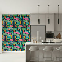 A vibrant bohemian patchwork wallpaper featuring colorful floral blocks in bright rainbow tones.