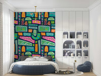 Rainbow-hued floral blocks and retro shapes forming a bold bohemian patchwork wallpaper.