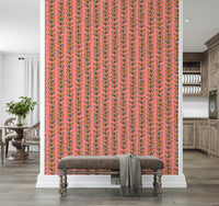A vibrant wallpaper with whimsical retro vines arranged in evenly spaced stripes on pink.