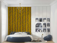 A bold mustard wallpaper with repeated retro leaf motifs lined up in vertical vine formations.
