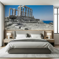 The wallpaper captures the timeless grandeur of the Poseidon Temple set against a serene Mediterranean sky.