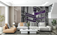 A contemporary wallpaper featuring purple directional signs pointing to famous London streets and landmarks.