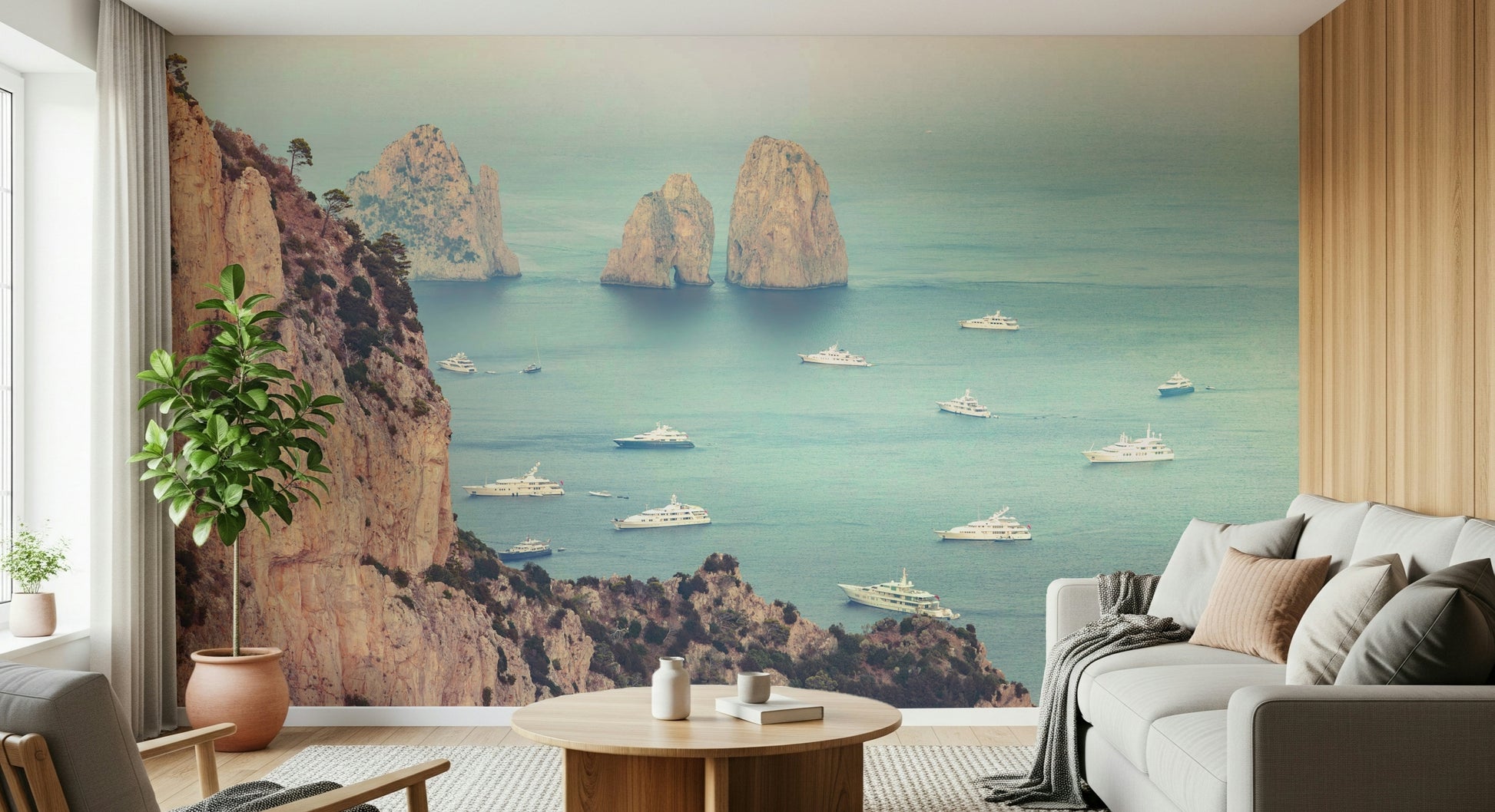 This wallpaper captures the stunning Faraglioni cliffs rising from turquoise waters with yachts drifting below.