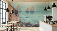 A serene coastal wallpaper featuring the iconic Faraglioni cliffs framed by calm blue sea and scattered boats.