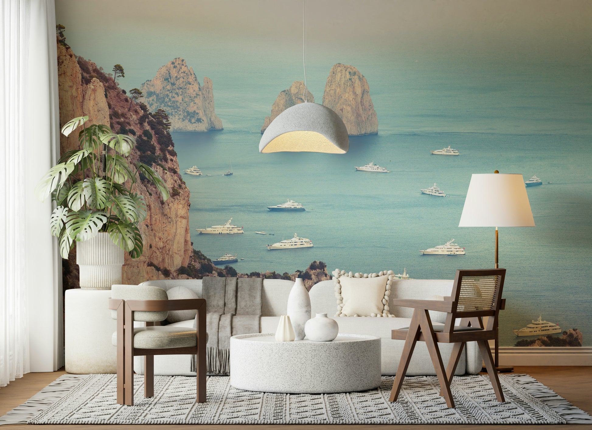 This wallpaper highlights the dramatic Faraglioni cliffs with soft golden tones and a sea full of anchored yachts.